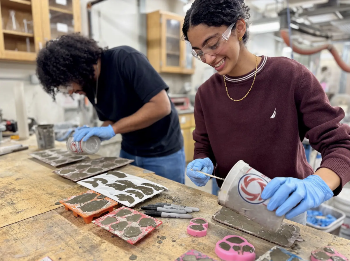 McCormick senior Aya Ibrahim, who serves as the vice president of The American Society of Civil Engineers at NU, pours concrete into a heart-shaped mold. 